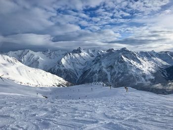 Scenic view of snow covered mountains against sky