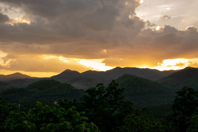 Scenic view of silhouette mountains against sky during sunset