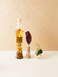 Bottle with olive oil and spices. infographic food style. close up. cooking concept.