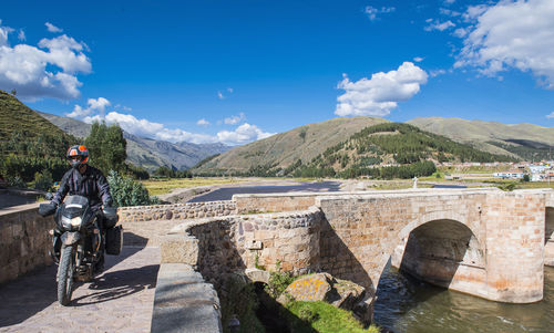 Motorbike driving over a bridge of the urubamba river, peru