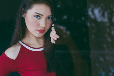 Midsection of beautiful young asian woman with red shirt