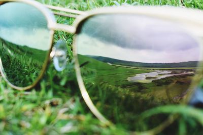 Close-up of sunglasses on field