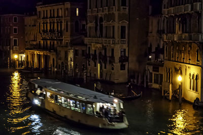 Boats in canal at night