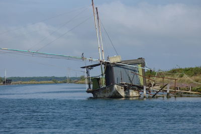 Sailboat in sea against sky