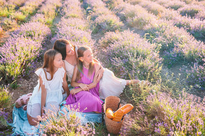 Woman sitting on purple flowering plants