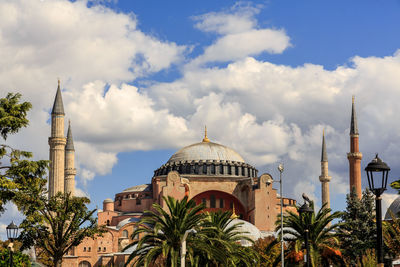 Panoramic view of mosque and trees against sky