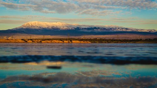 Scenic view of dramatic landscape against sky during sunset