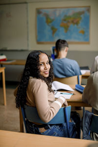 Portrait of girl siting in junior high classroom