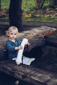 Cute baby girl playing with toy on wooden table