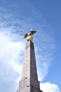 Low angle view of statue against sky