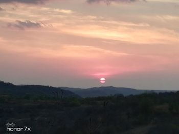 Scenic view of silhouette landscape against romantic sky at sunset