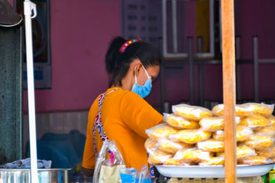 Young woman looking at food outdoors