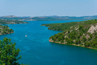 High angle view of bay against blue sky