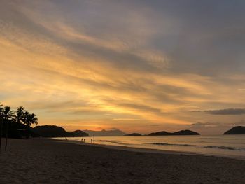 Scenic view of beach against sky during sunset