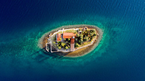 Aerial view of house surrounded by sea
