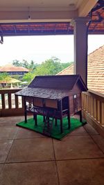 Empty chairs and table against building