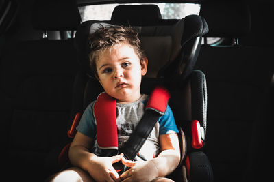 Portrait of boy sitting in car