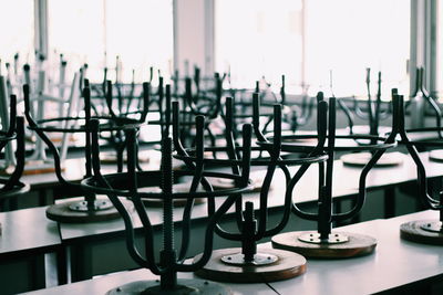 Stools arranged upside down on table in restaurant