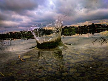 Water splashing in lake against sky