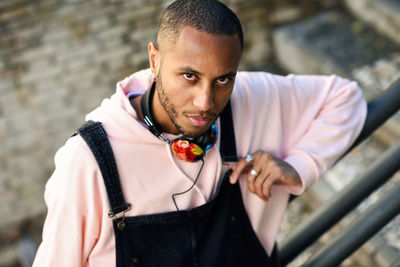 High angle portrait of young man standing in city