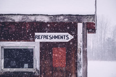 Close-up of signboard on a snowy day