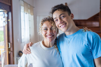 Portrait of young man standing at home