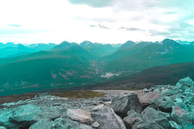 Scenic view of mountains against cloudy sky