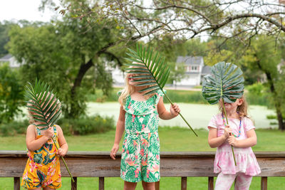 Full length of girl and plants against trees