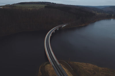 Road by river against sky
