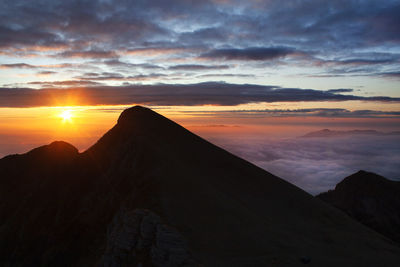 Scenic view of mountains against sky during sunset