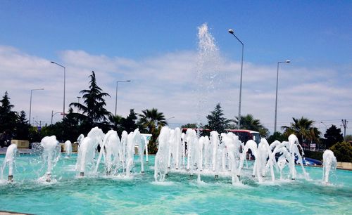 View of water splashing against blue sky