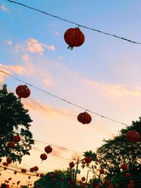 Low angle view of lanterns hanging against sky