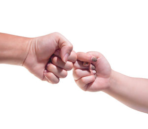 Close-up of couple hands over white background