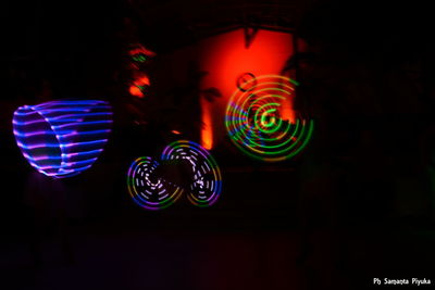 Low angle view of illuminated lights at night
