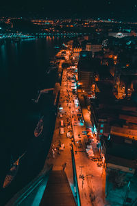 High angle view of illuminated harbor in city at night