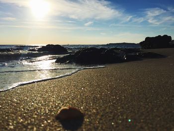 Rocks at shore against sky