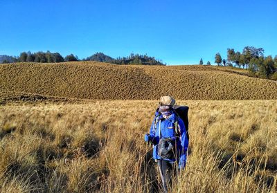 Rear view of person standing on field