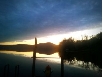 Scenic view of lake against cloudy sky