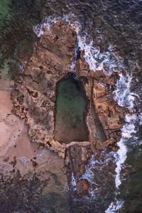 Aerial view of rock against sea