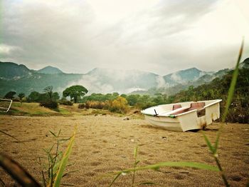 Scenic view of mountains against cloudy sky