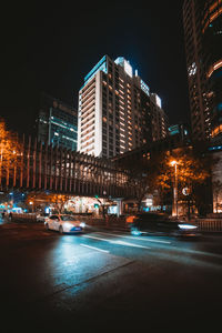 Illuminated city street at night