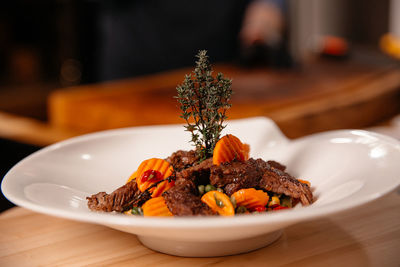 Beef meal presentation on white plate. chef specialty dish.