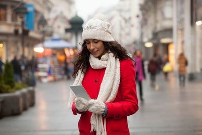 Woman smiling in city during winter