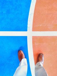 Low section of man standing on floor