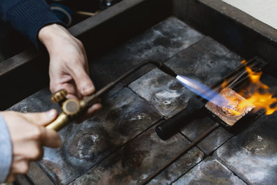 Midsection of man welding metal