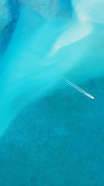 High angle view of airplane flying over sea