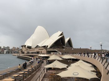 Buildings in city against cloudy sky