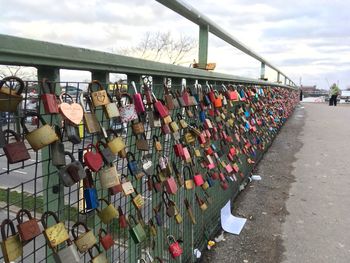 Padlocks hanging on fence