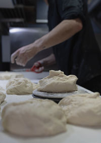 Pizza chef makes a pizza by molding the dough