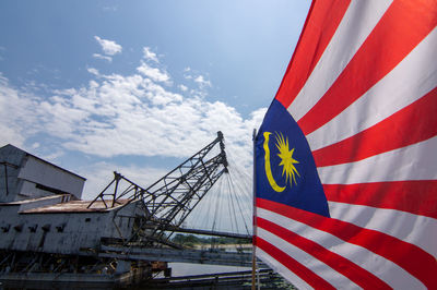 Low angle view of flag against blue sky